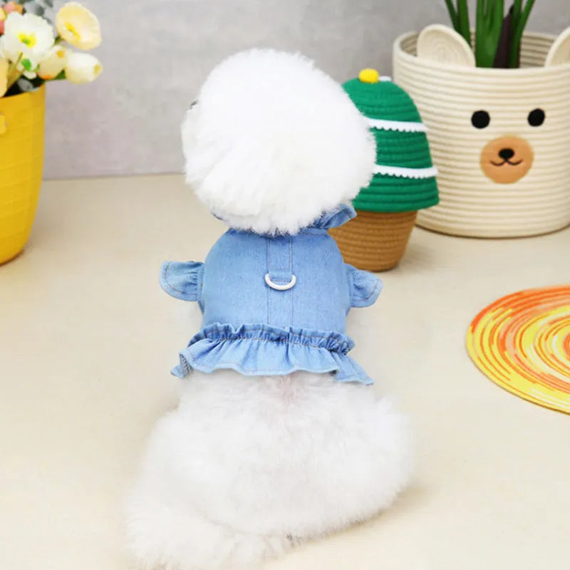 Blue denim dress for a dog or cat with ruffles and a metal leash hook on the chest.