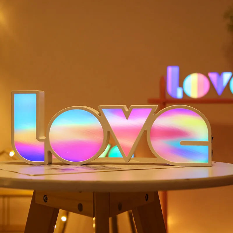 LED decorative light with rainbow-coloured LOVE word on plastic shade