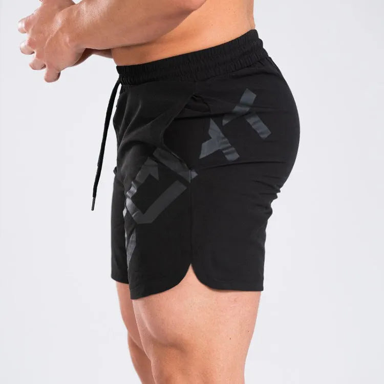 Men's black elastic running shorts with a mid-waist and knee-length cut on a plain background.
