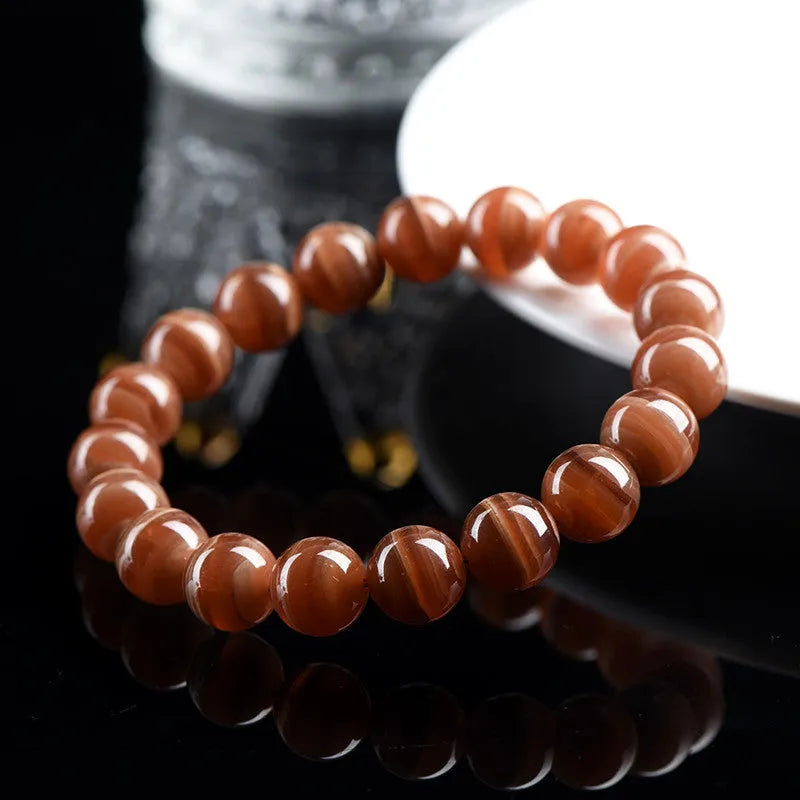 Natural old mine rhodochrosite round bead bracelet with geometric design and Ruyi elements.