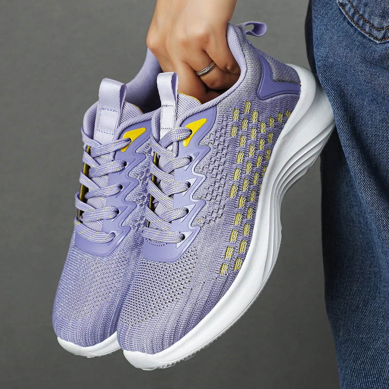 Women's Lavender Purple Flyknit running shoes with striped pattern and mesh lining on white background