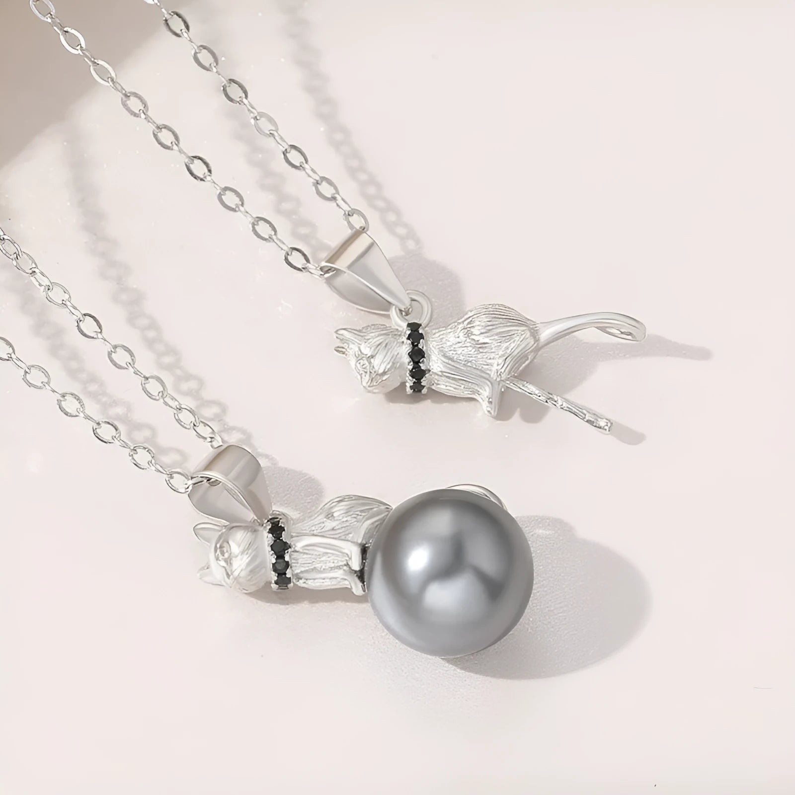 Sterling silver cat pendant necklace on a chain, showcasing the feline design in an elegant style.