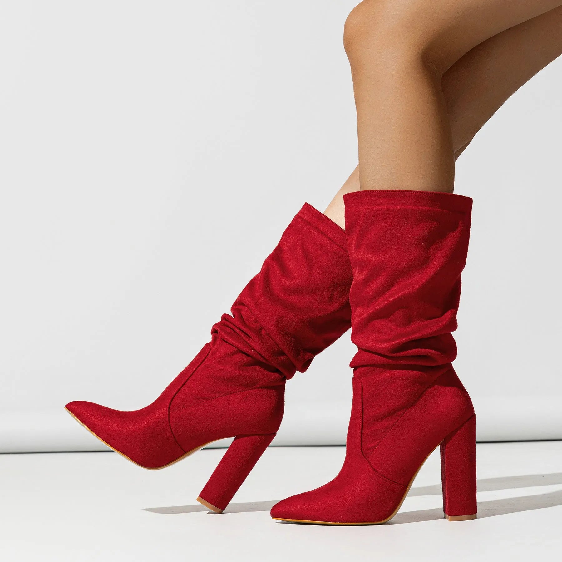 Women's black chunky heel pointed-toe suede boots with mid-calf length and oversleeve design