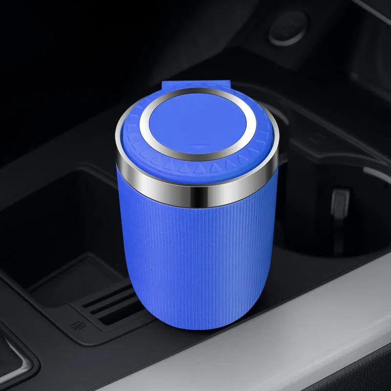 Metal ABS car ashtray with cover and blue LED light against a dark background