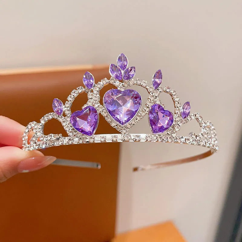 Children's electroplated alloy metal headband with crown shape and crystal decoration in pink, blue, or purple.