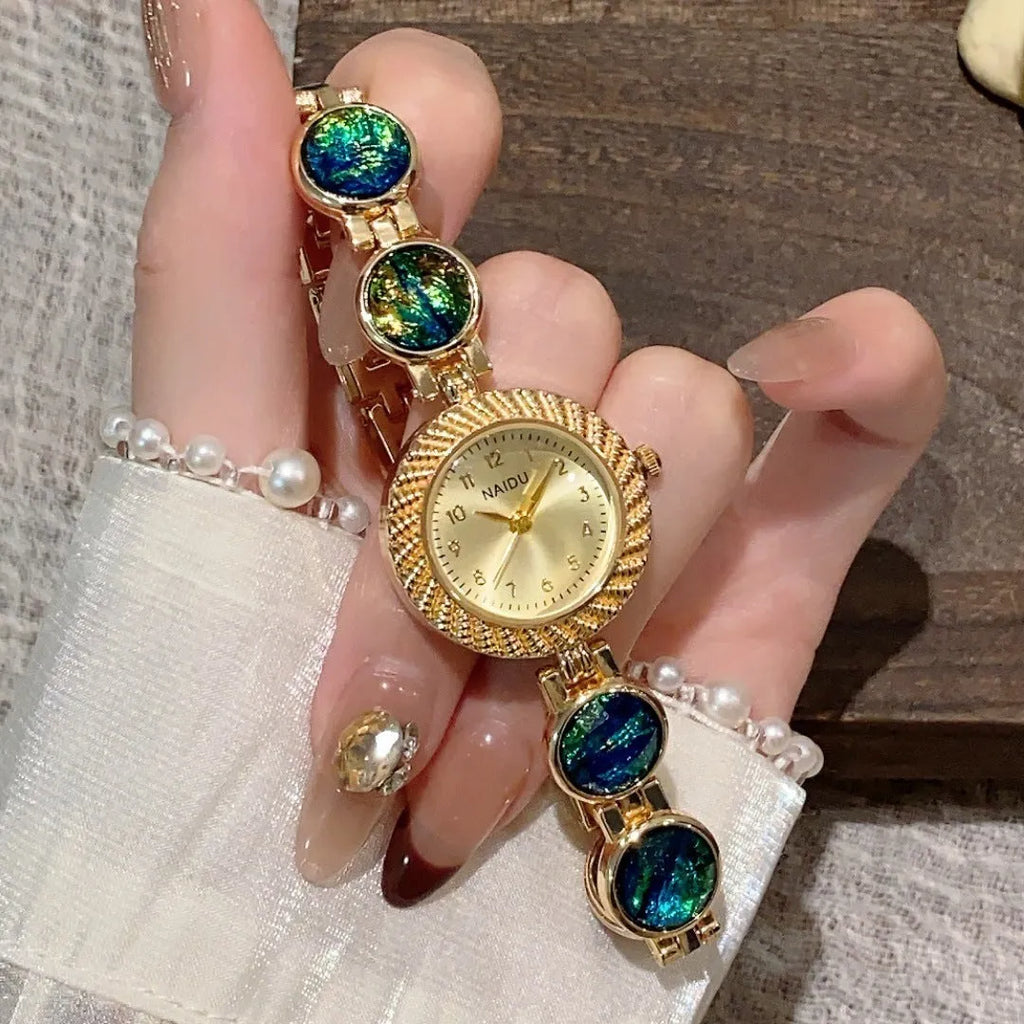 Women's quartz watch with 25mm round dial in zinc alloy case, showing spiral crown