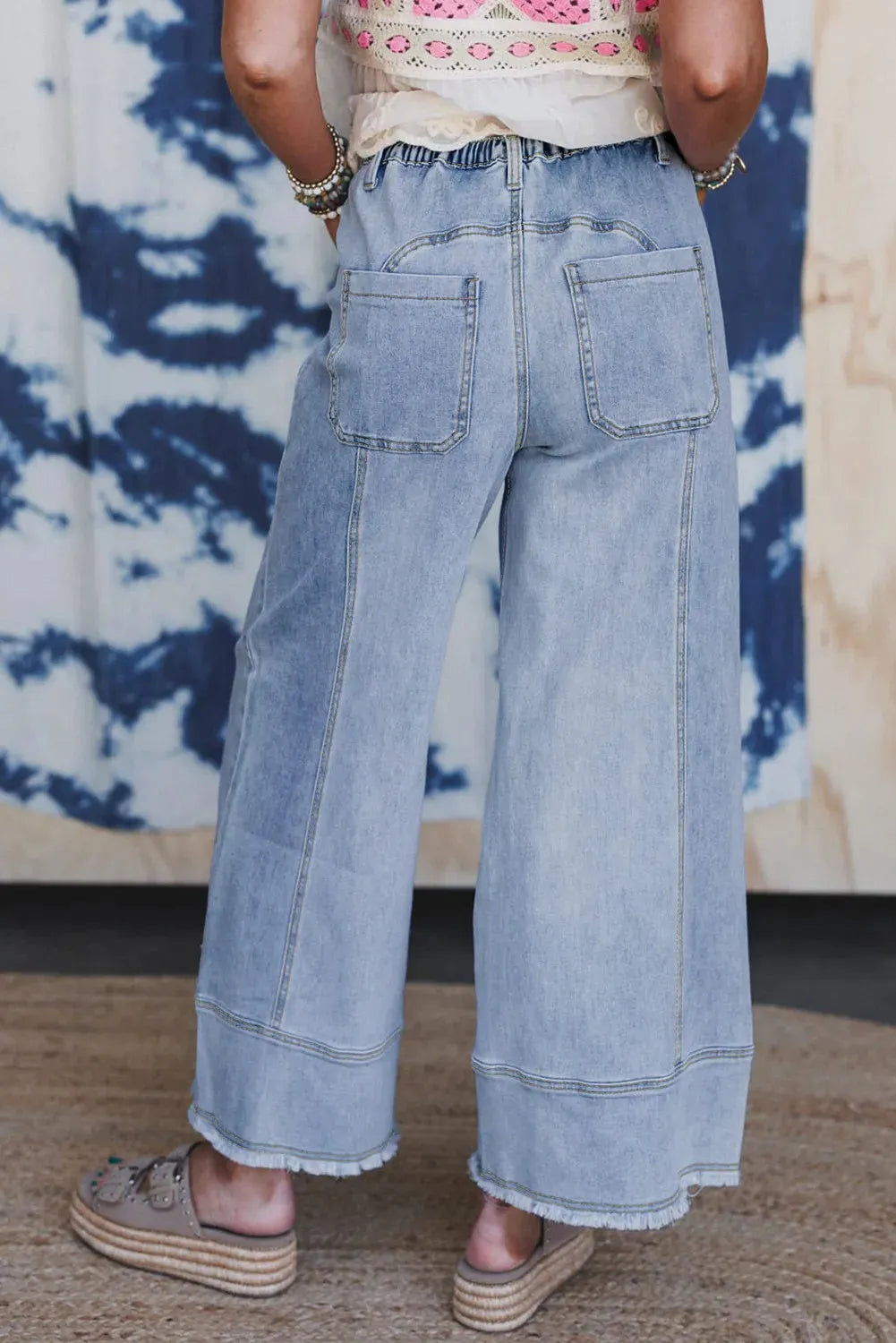 Beau Blue women's wide leg denim trousers featuring a drawstring waistband and raw hem detailing.