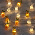 Easter LED bunny string lights with carrot and transparent white rabbit bulbs on a dark background