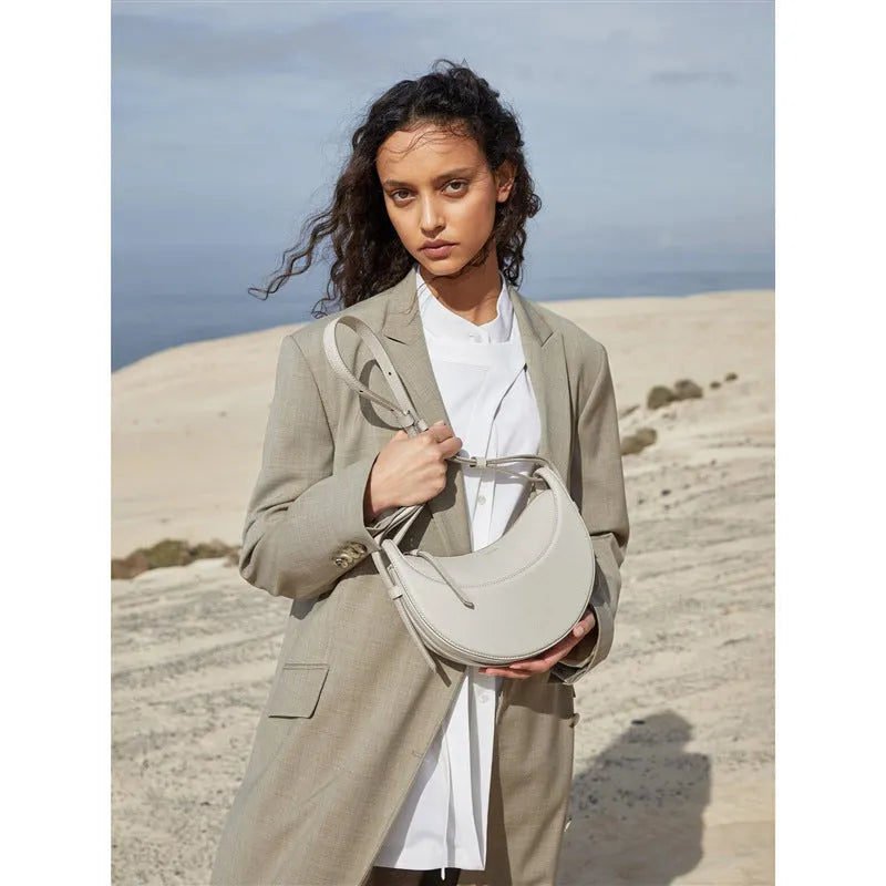 Women's crescent shoulder bag with litchi pattern texture, available in camel, black, chalk white, and elephant gray