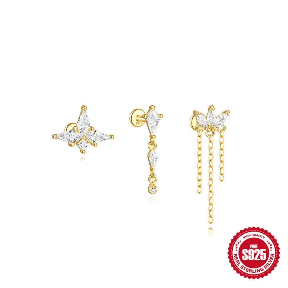 Geometric kite-shaped sterling silver stud earrings with rhinestones and a gold chain tassel.
