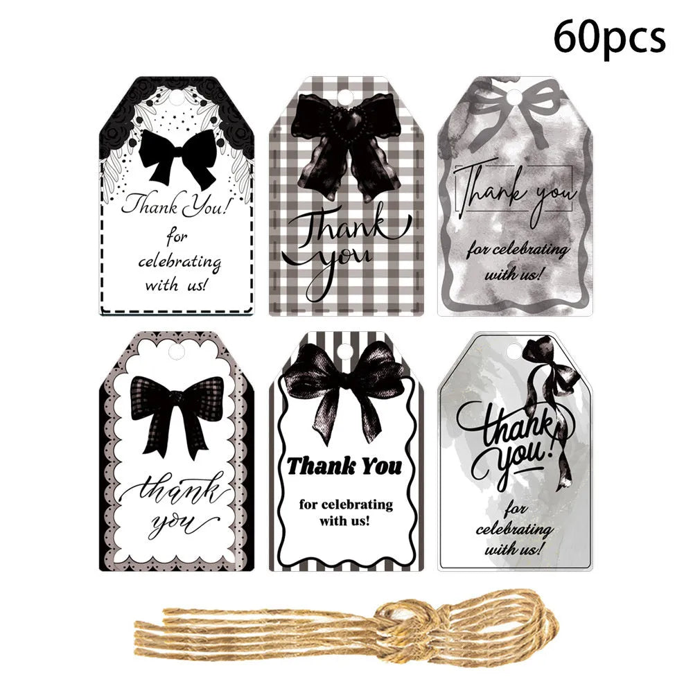 Set of 60 decorative bowknot-shaped paper gift tags with natural jute twine for birthdays.