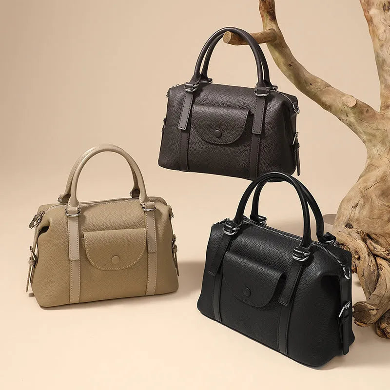 Genuine leather street trend handbag with lock detail and contrast stitching in 27x12x20 cm size