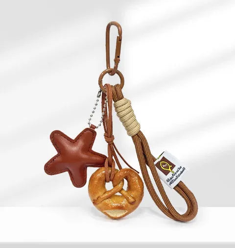 Handmade soda bread handbag pendant with brown star details and carrying strap