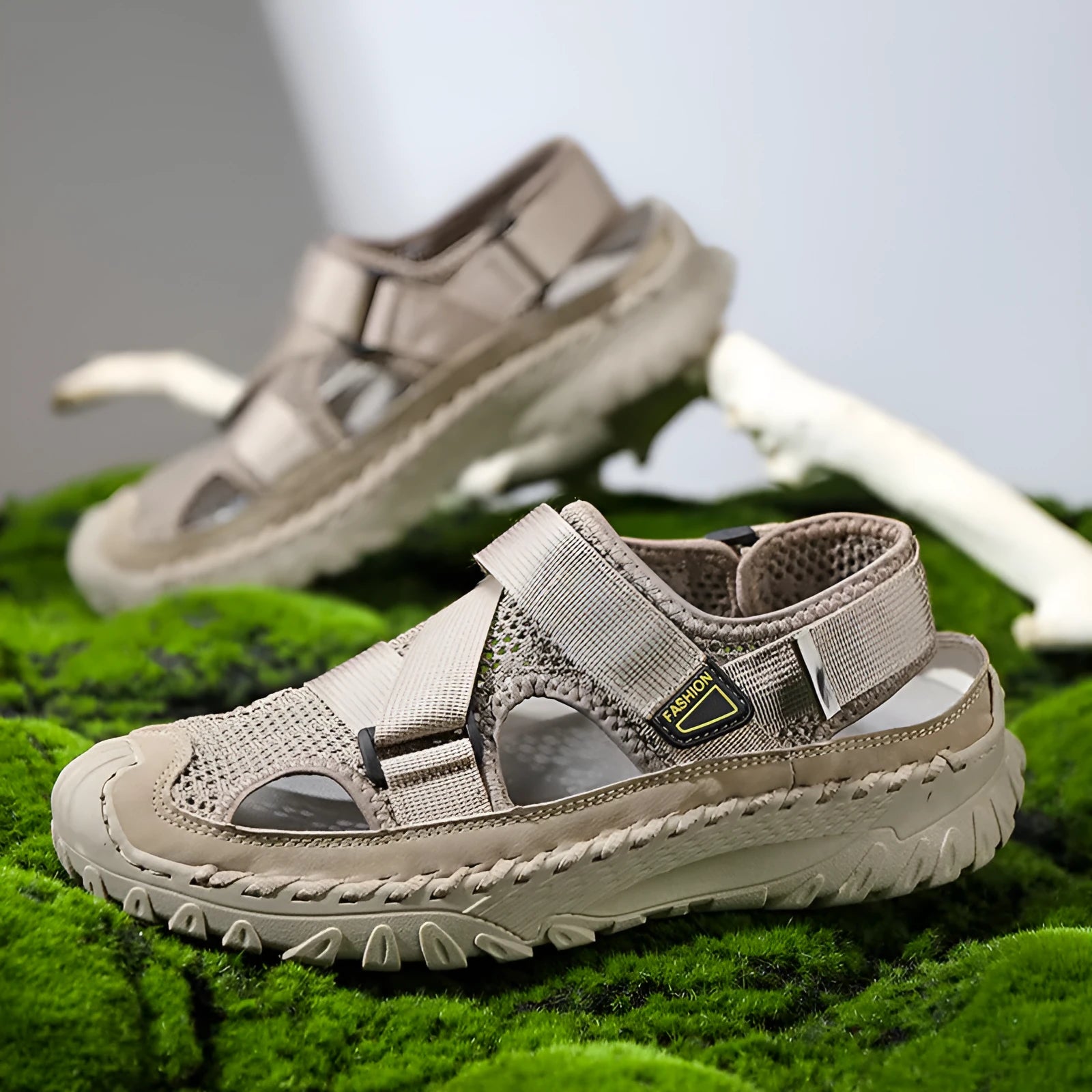 Men's grey genuine leather sandals with mesh lining and an elastic band on a rubber sole.