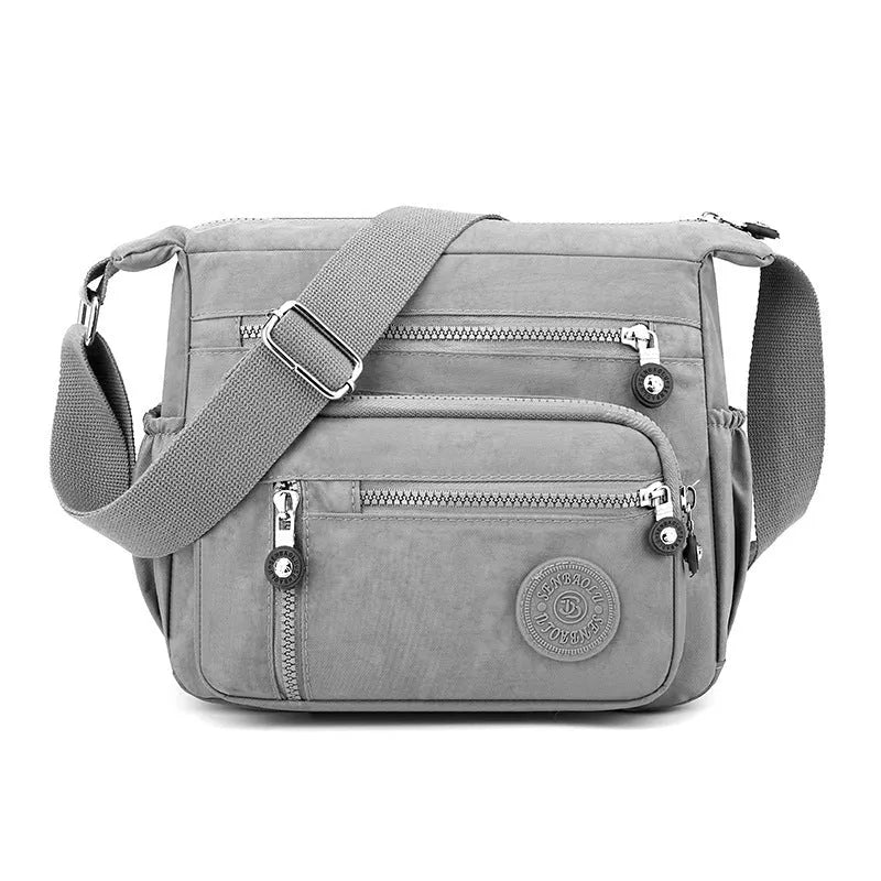 Grey lightweight nylon messenger bag with large capacity and single shoulder strap.