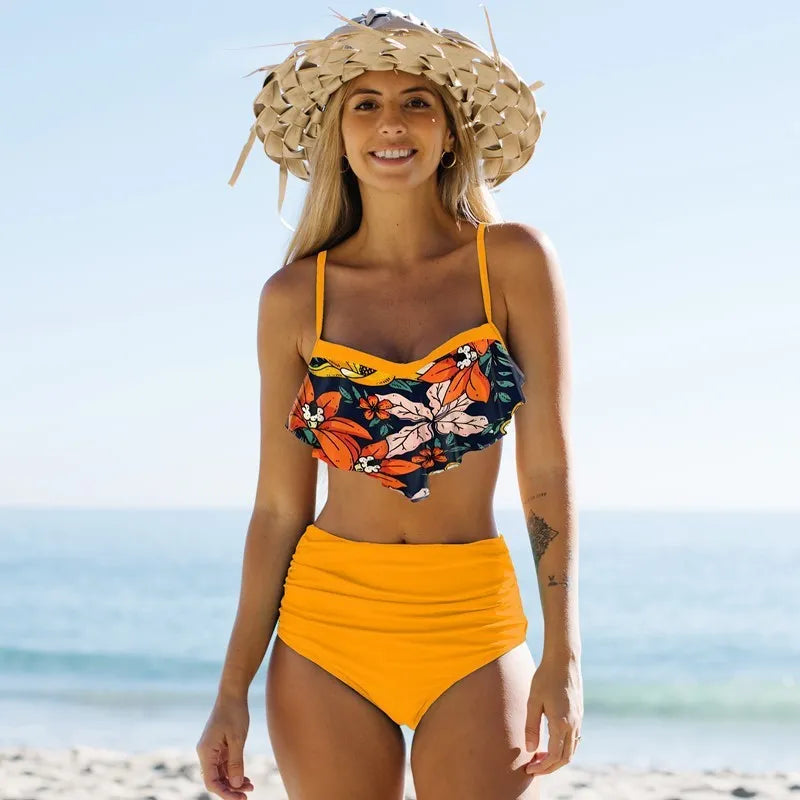 Women's high-waisted pleated bikini swimsuit in floral print, available in green and blue colours