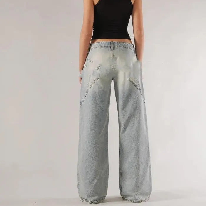 Blue cotton loose straight wide leg women's trousers on a hanger, showing low waist and stitching detail.