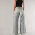 Blue cotton loose straight wide leg women's trousers on a hanger, showing low waist and stitching detail.