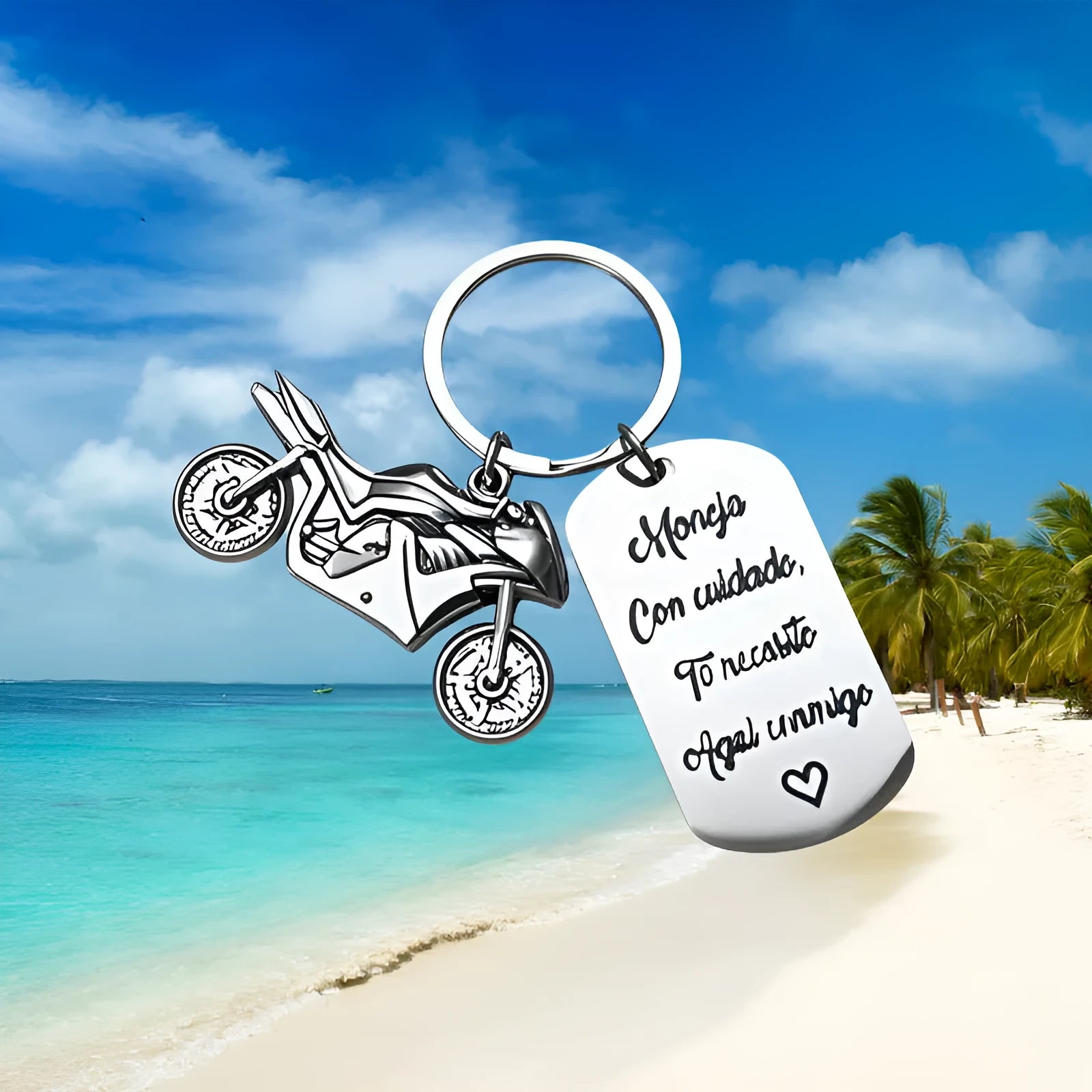 Stainless steel motorcycle keychain with a dark flannel storage pouch on a grey background.