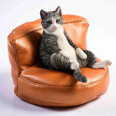 Lazy cat model ornament with sofa on car dashboard, 7.5cm high resin decoration.