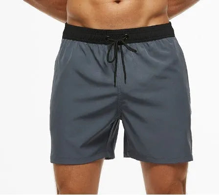 Men's blue athletic shorts with a stitching waistband, drawstring, and side headband pocket.