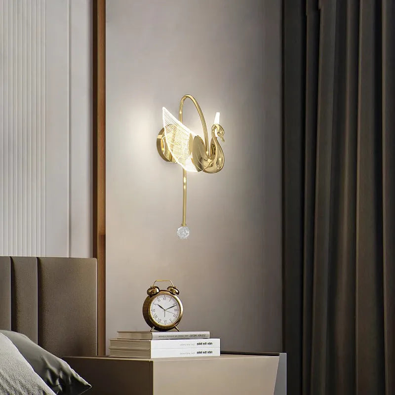 Gold swan-shaped wall lamp with acrylic shade and dimmable LED light.