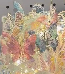Butterfly-shaped night lamp with glass lampshade on raw wood base