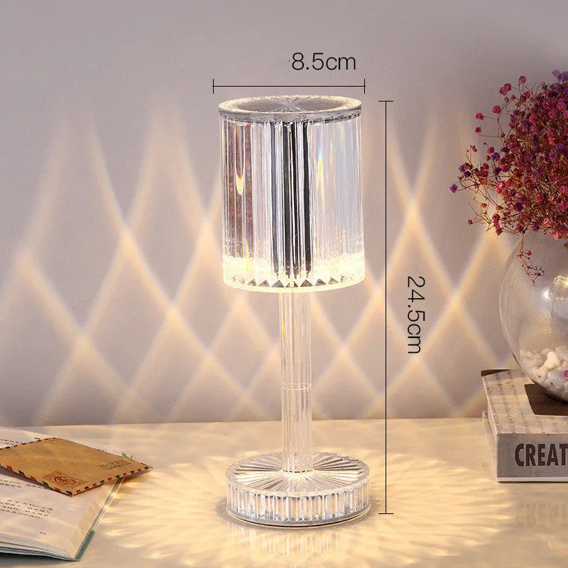 Amber K9 crystal table lamp with double-layered lampshade on a modern bedside table, warm LED light on medium brightness
