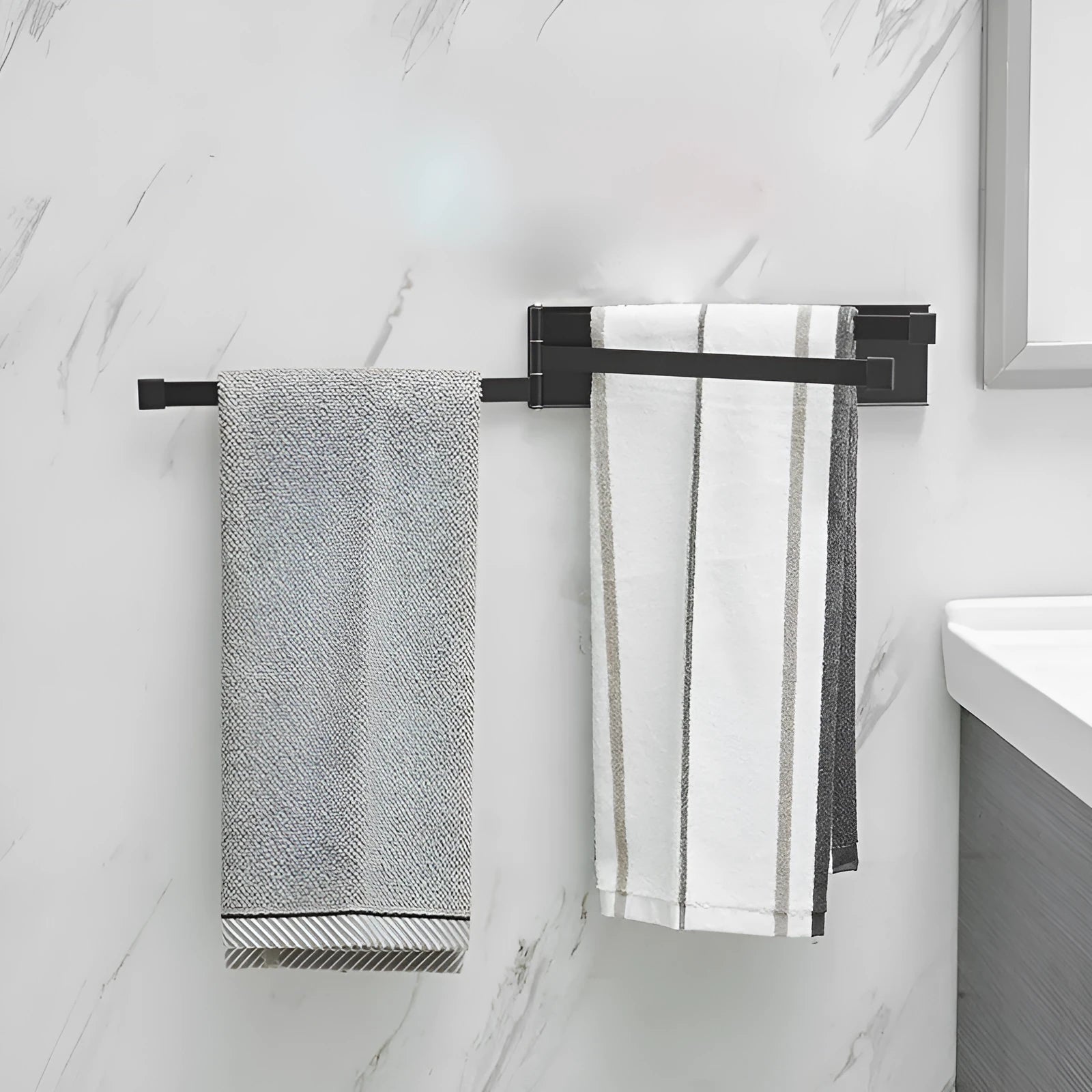 Black folding towel bar with adhesive installation for a no-drill bathroom fit.