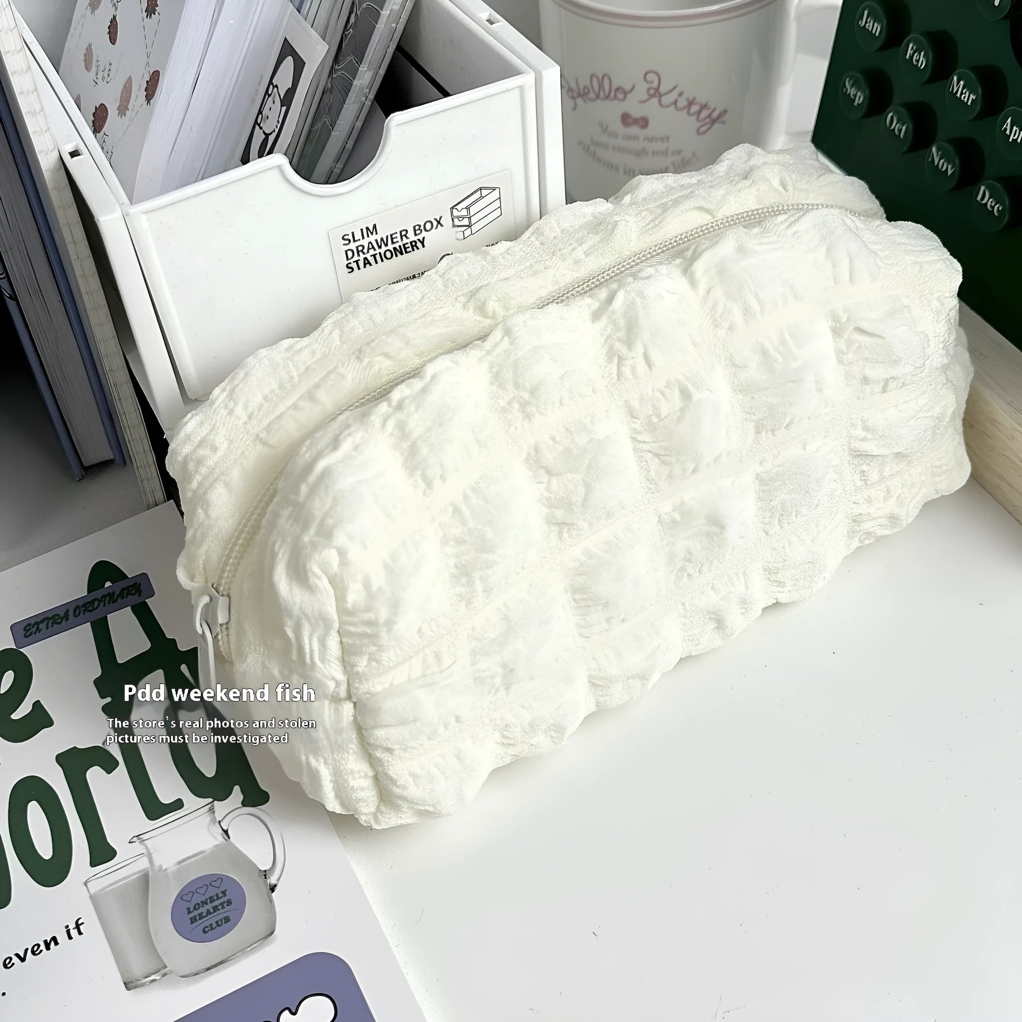 Beige fabric pencil case with a cream puff textured design for holding pens and pencils.