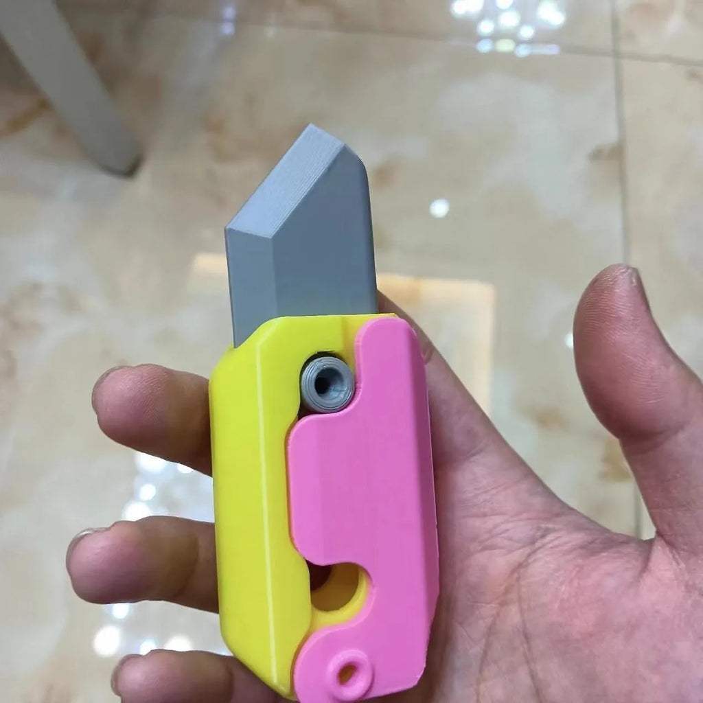 Carrot-shaped 3D printed plastic gravity fidget knife with orange purple green colour scheme