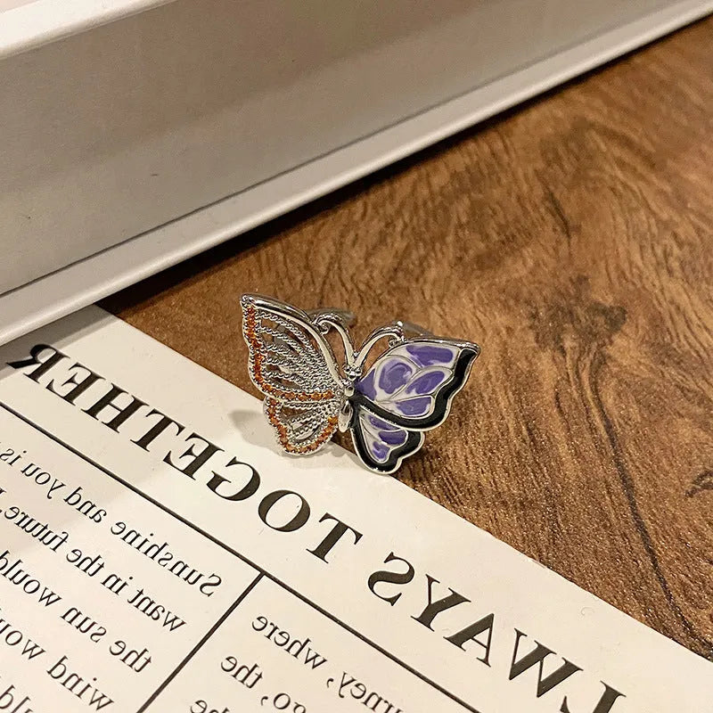 Copper butterfly women's ring with oil-drip finish showing open-loop design