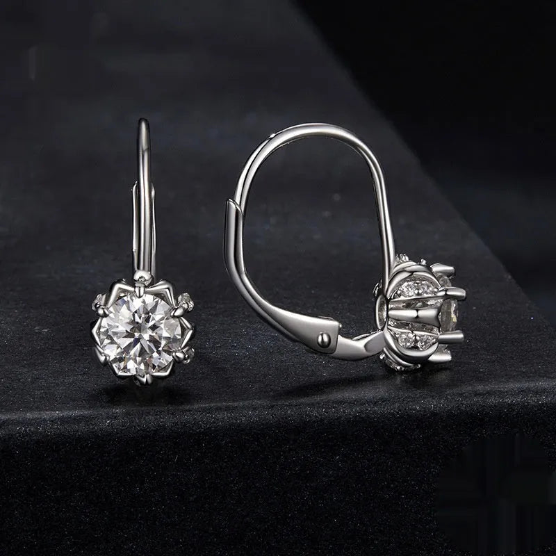 White gold plated sterling silver flower ear clip with moissanite centrepiece.