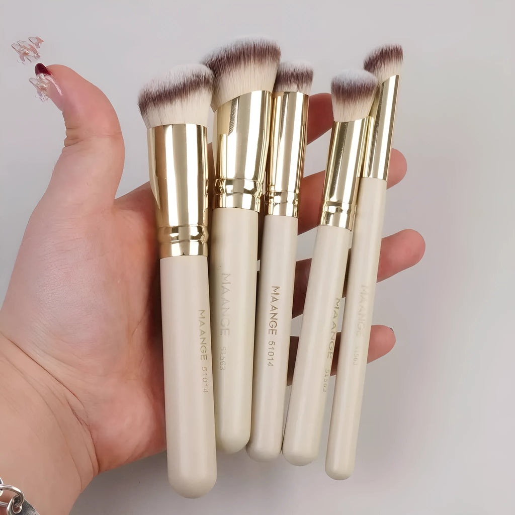Five apricot coloured makeup brushes including angled blush brush for contouring