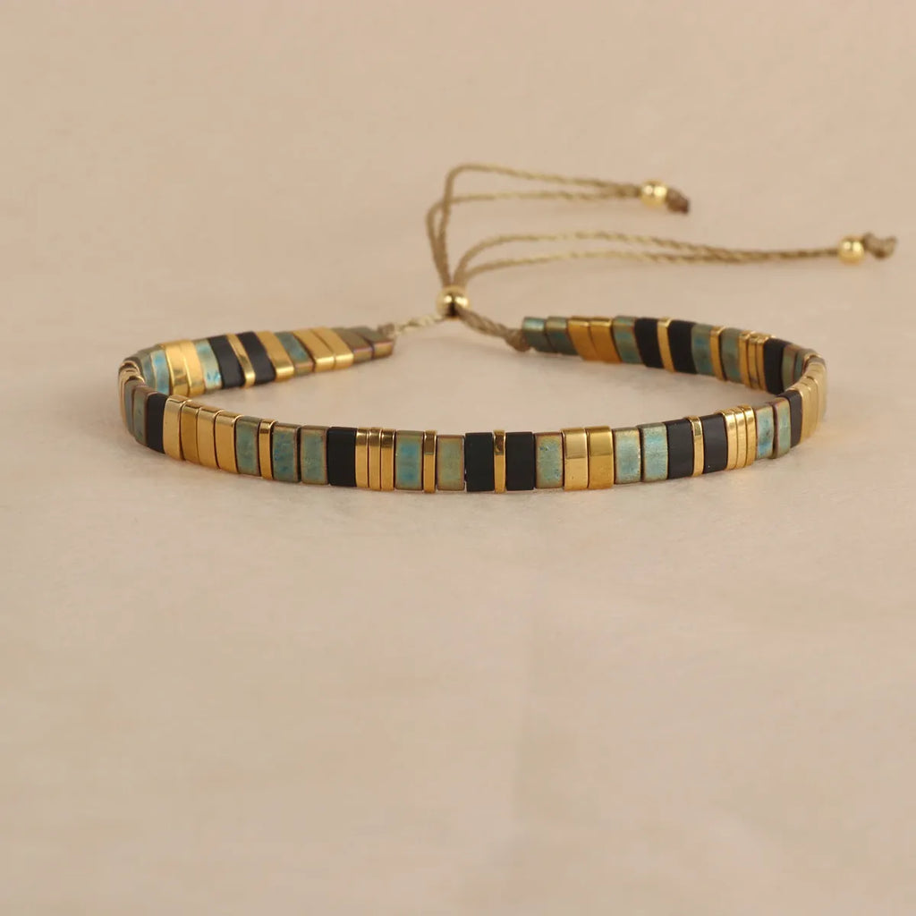 Geometric round glass bead bracelet in milky white, black, green, blue, or red.