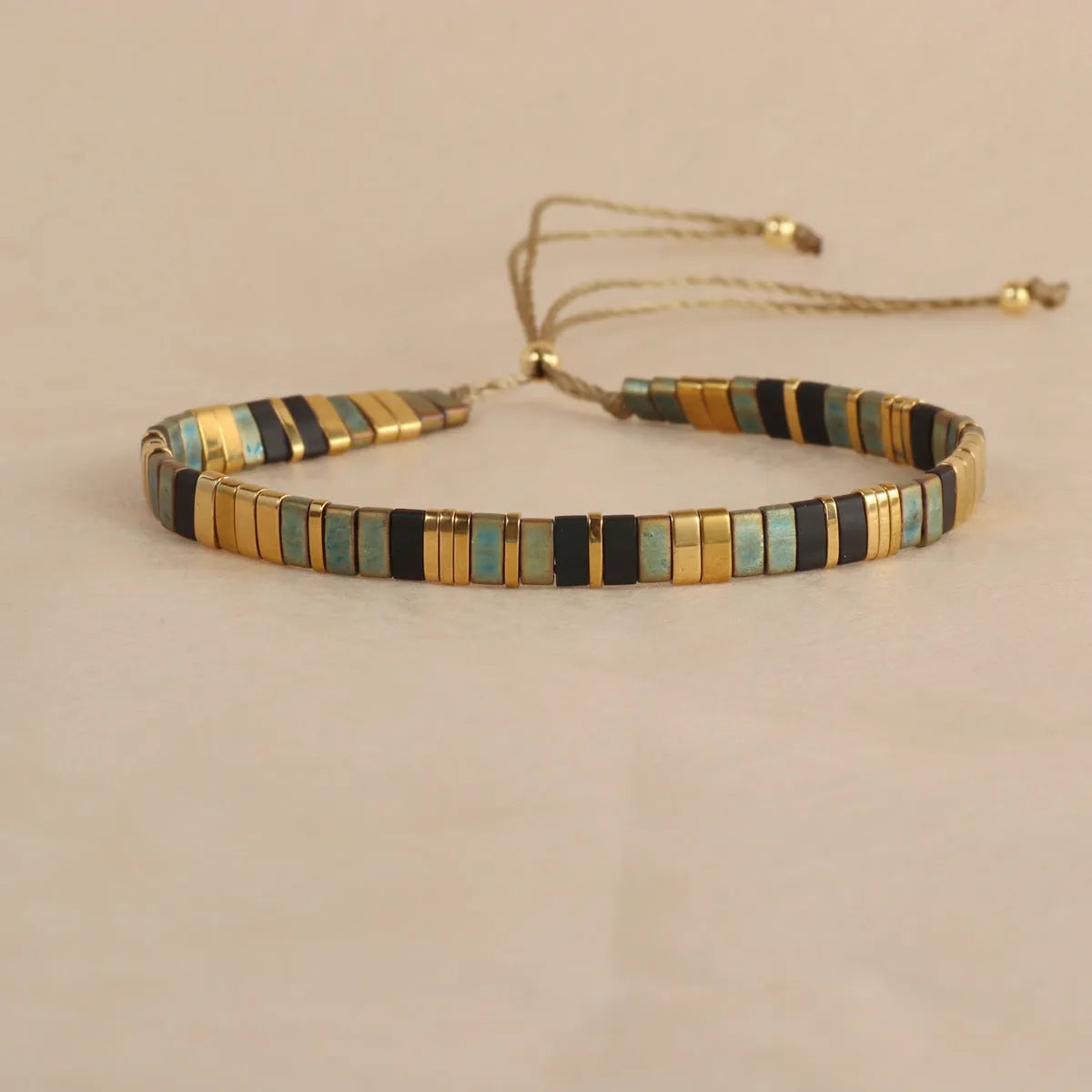 Geometric round glass bead bracelet in milky white, black, green, blue, or red.