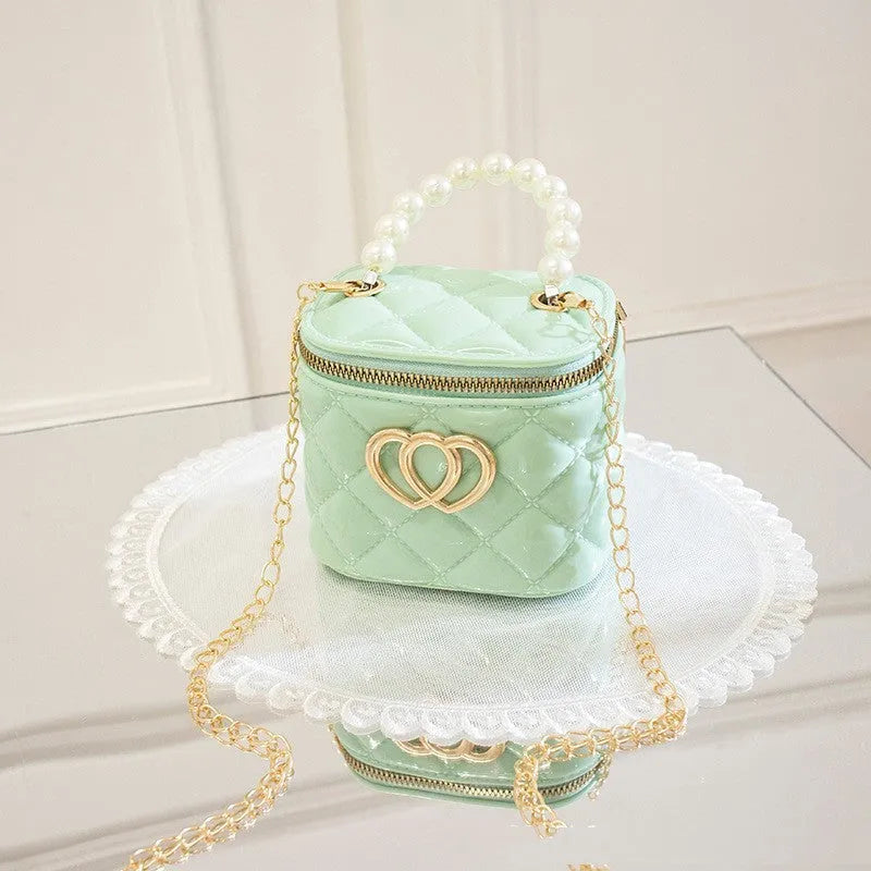 Women's white PVC bucket gel handbag with a red heart-shaped pattern lining.