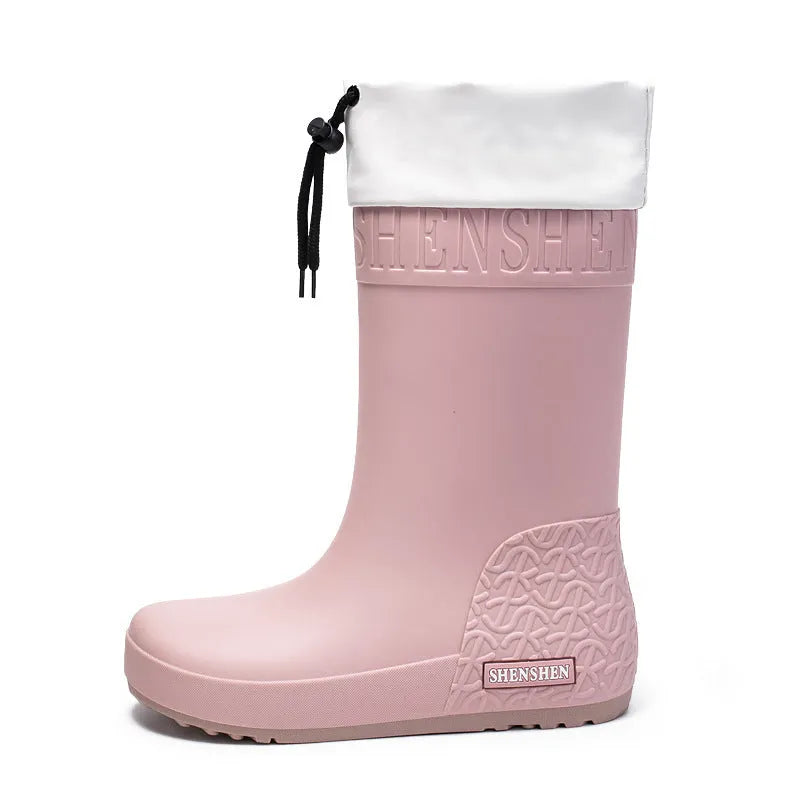 Women's solid colour PVC rain boots with non-slip sole in apricot, black, brown, and pink.
