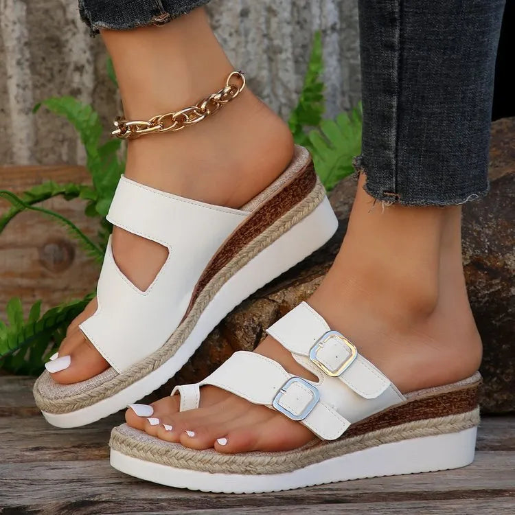 White patent leather wedge sandals with peep toe and woven finger fit straps