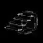 Transparent acrylic cosmetics storage rack with detachable shelves, displaying perfume bottles and small accessories