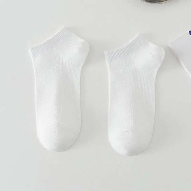 A pair of solid colour low-cut polyester boat socks for men, shown in one of six available colours.