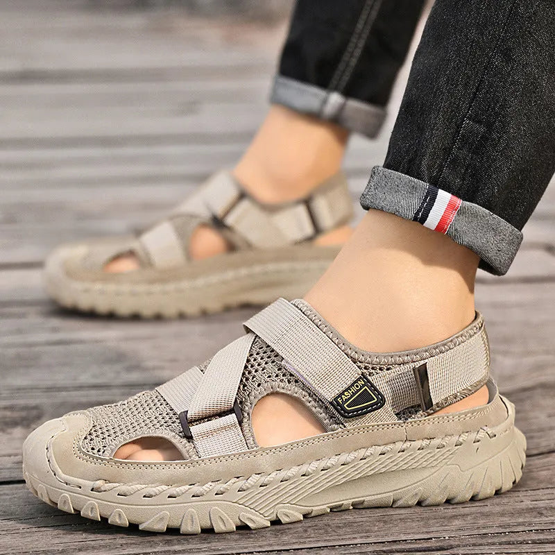 Men's grey genuine leather sandals with mesh lining and an elastic band on a rubber sole.