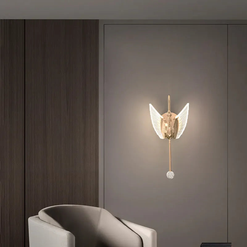 Gold swan-shaped wall lamp with acrylic shade and dimmable LED light.