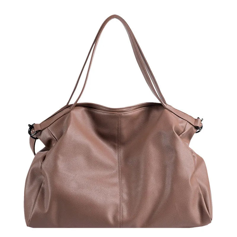 Large horizontal soft PU messenger bag in black with zip opening and long shoulder strap.