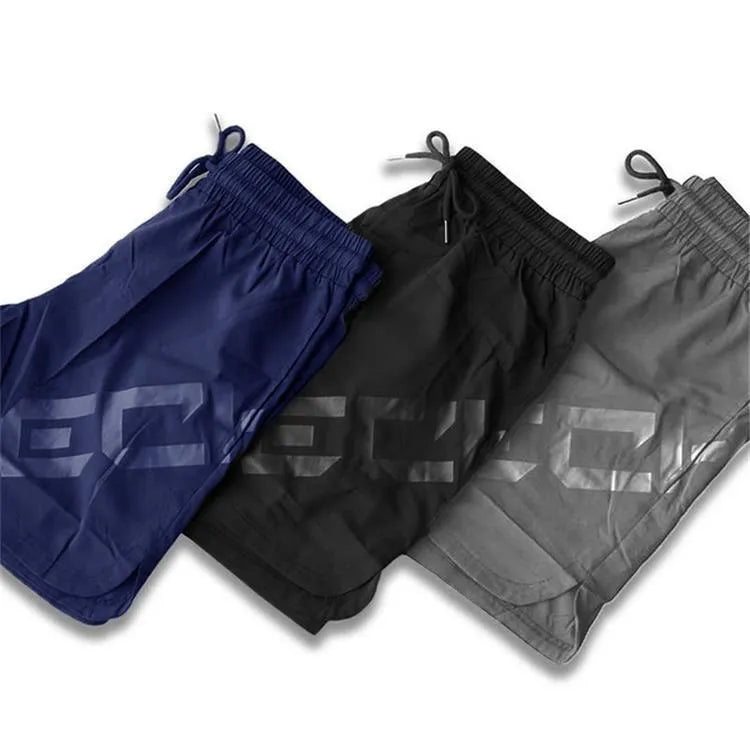 Men's black elastic running shorts with a mid-waist and knee-length cut on a plain background.