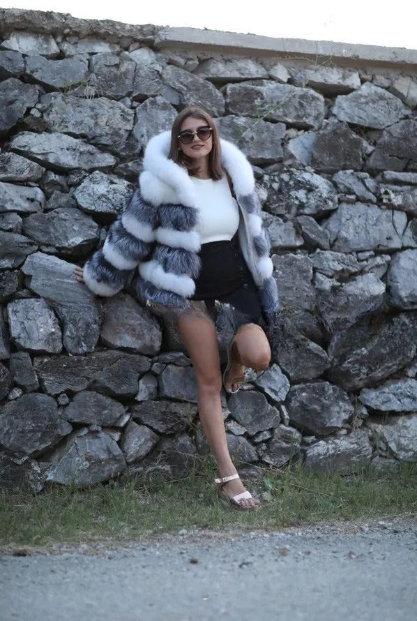 Loose-fitting hooded women's coat in artificial fur, shown in brown and white silver fox colours.
