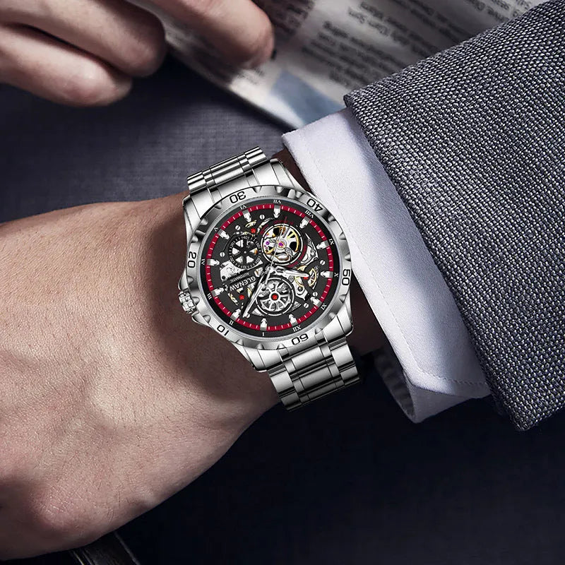 Silver automatic mechanical watch with hollow-out design showing luminous dial and stainless steel strap