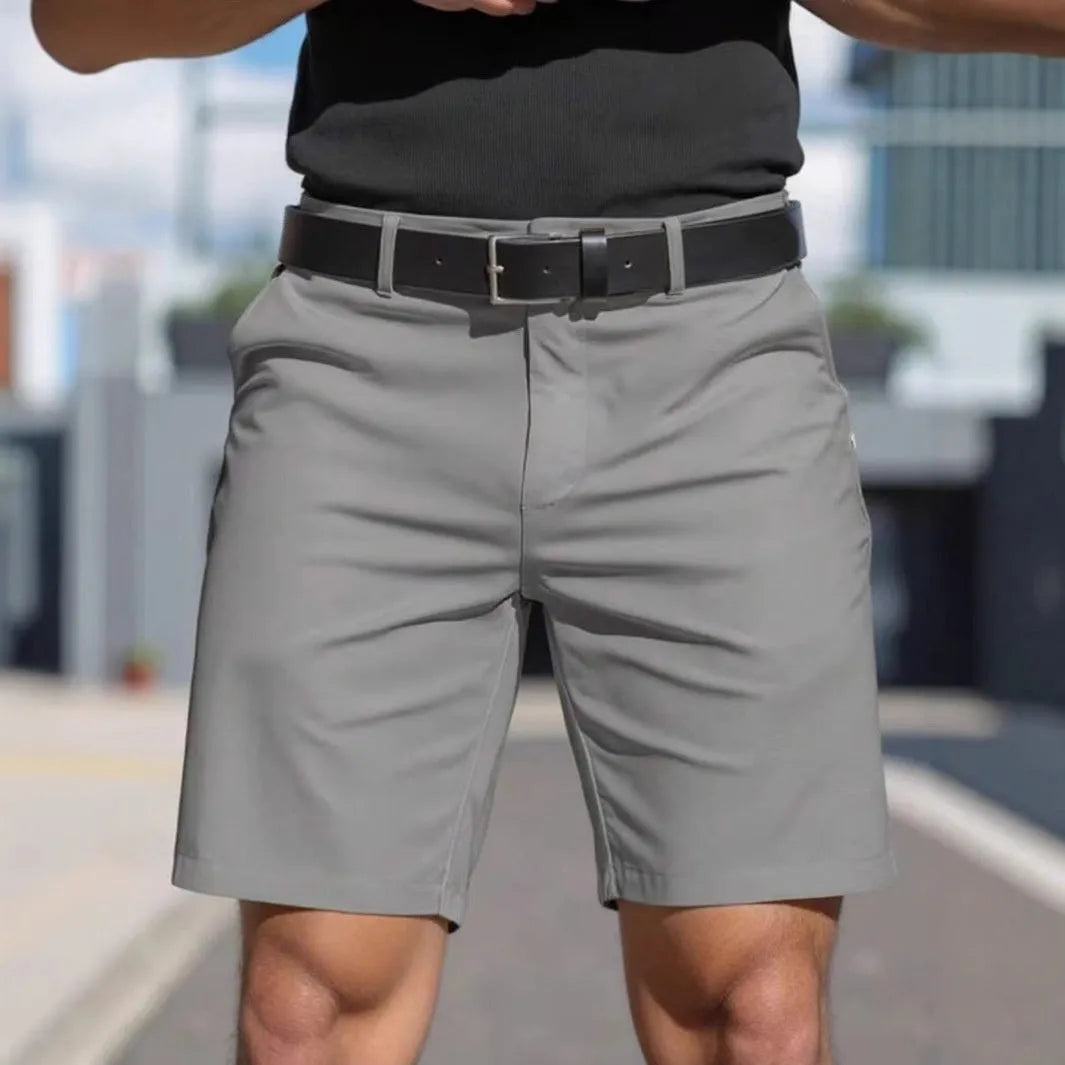 Men's straight cut solid colour shorts in light blue, showing fifth pants length and micro elastic polyester fabric.