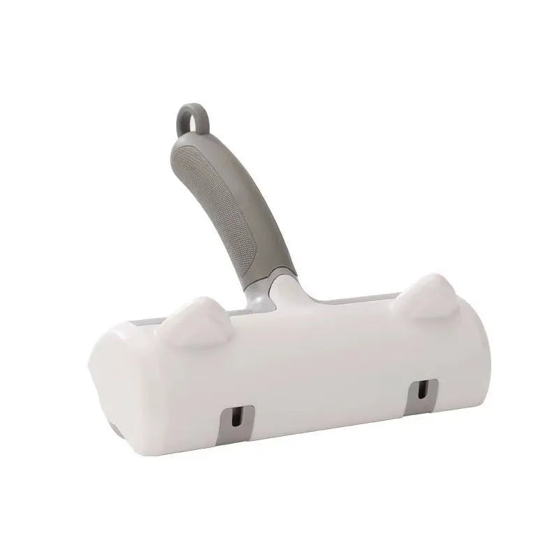 Mint green manual brush for removing cat hair from furniture and fabrics, showing its size.