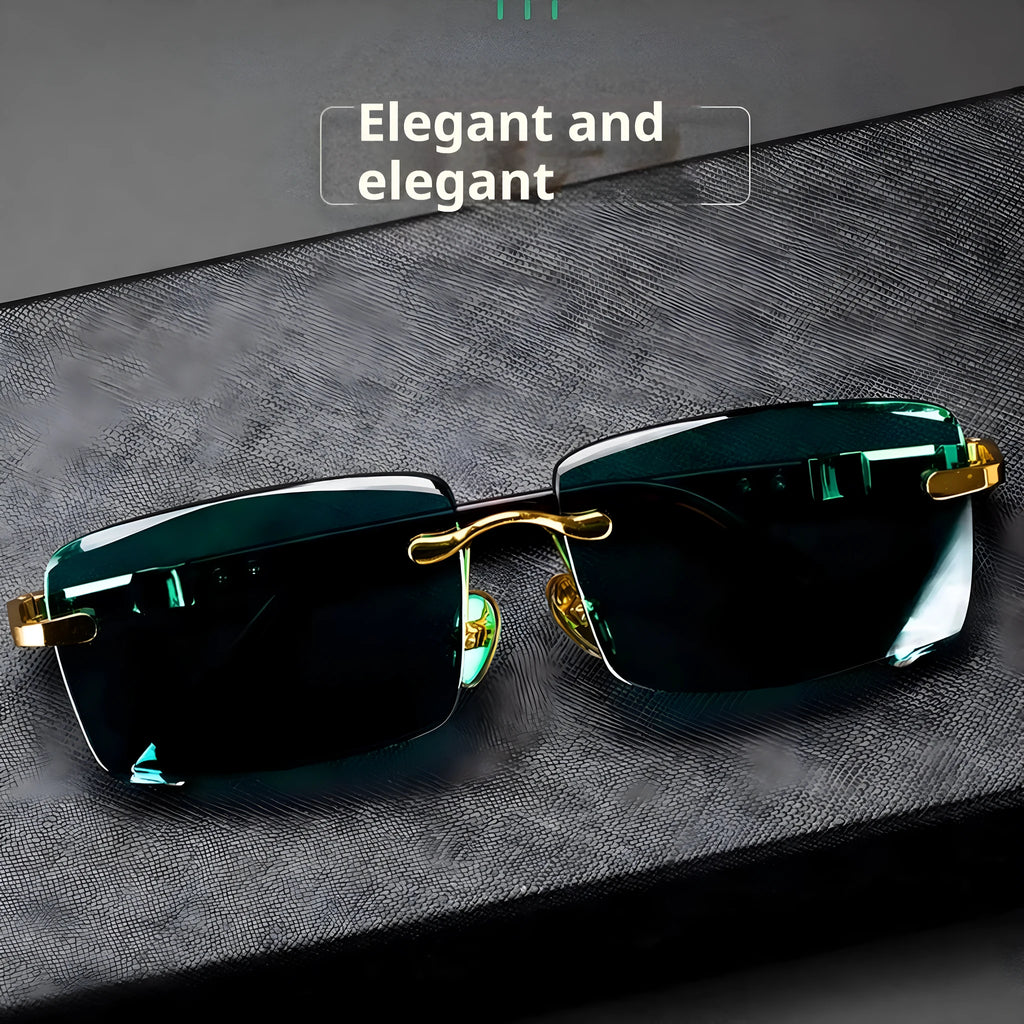 A pair of dark green frameless crystal sunglasses with a gold-tone temple arm on a case.